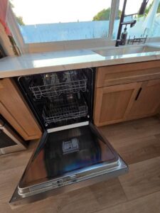 Clean and organized kitchen by Airbnb Cleaning in Orange County, with the dishwasher open