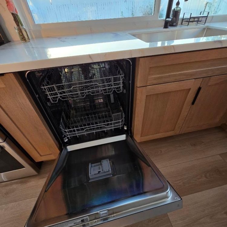 Clean and organized kitchen by Airbnb Cleaning in Orange County, with the dishwasher open